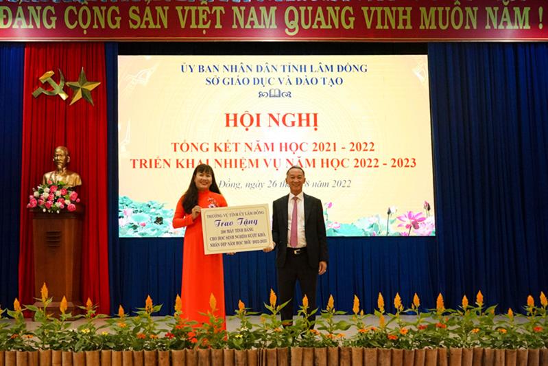 Giám đốc Sở GDĐT Lâm Đồng Phạm Thị Hồng Hải nhận bảng tượng trưng 200 máy tính của Ban Thường vụ Tỉnh ủy trao tặng học sinh nghèo vượt khó